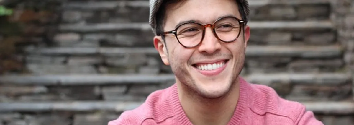 man smiling at the base of steps
