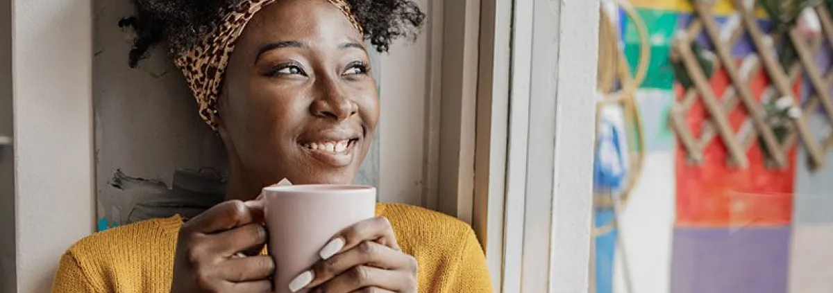 woman smiling drinking coffee or tea
