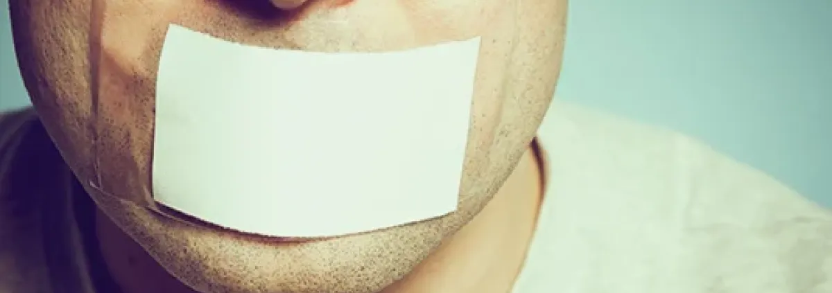 man with white tape over his mouth