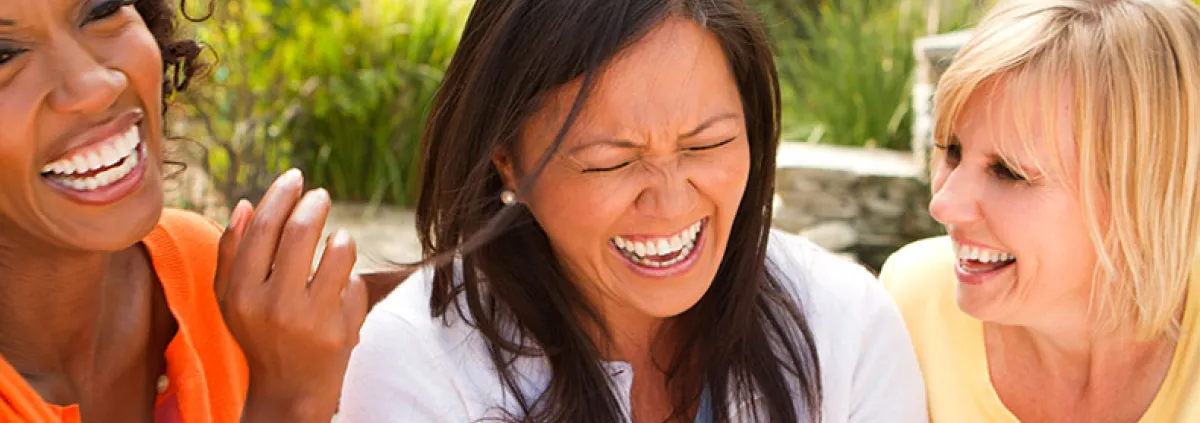 three female friends laughing hard