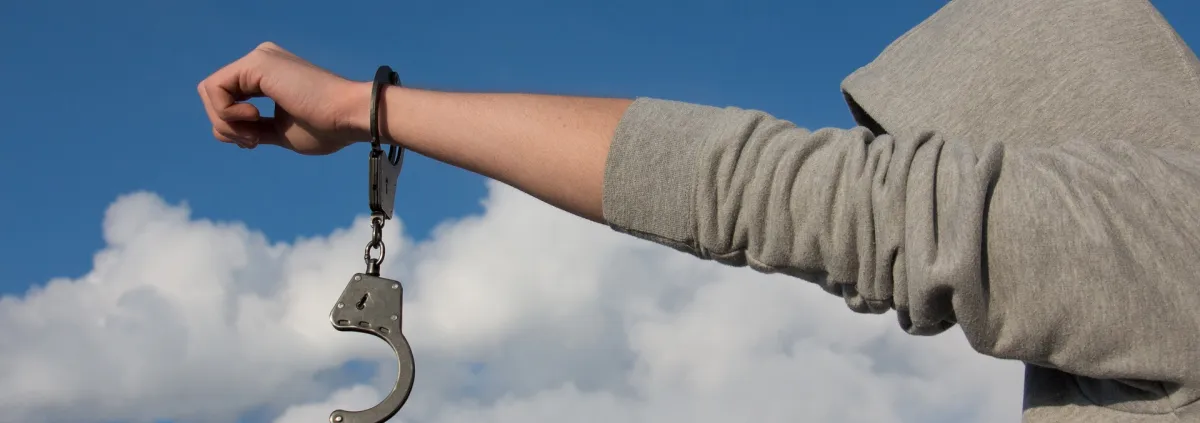 man in hoody with handcuffs