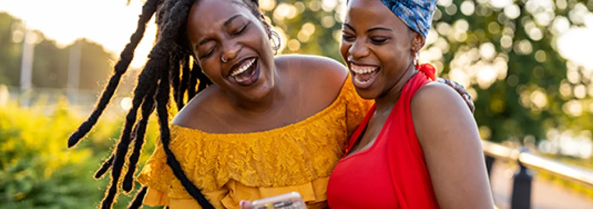 Two female friends hugging and laughing