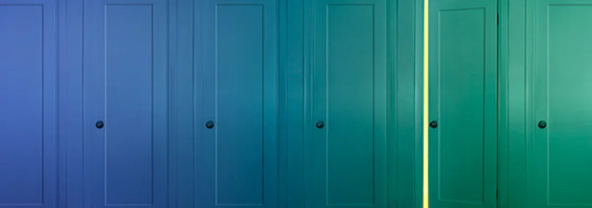 several closed doors with one cracked open