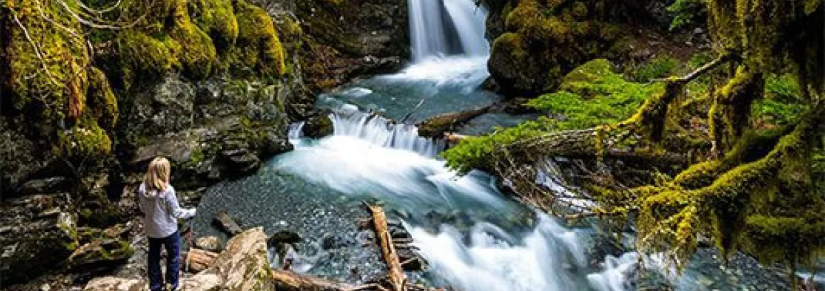 woman beside a waterfall