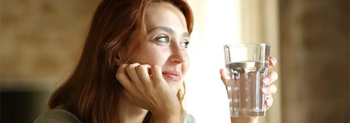 woman holding a glass of water